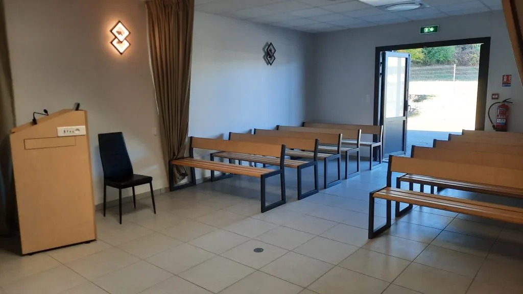 Salle de cérémonie omniculte des Pompes Funèbres avec pupitre et bancs